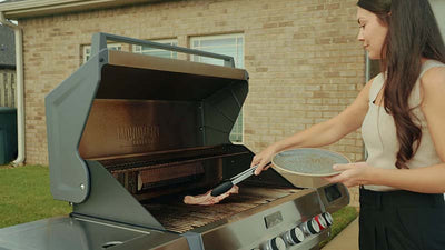 Woman grilling with a barbecue in an outdoor setting