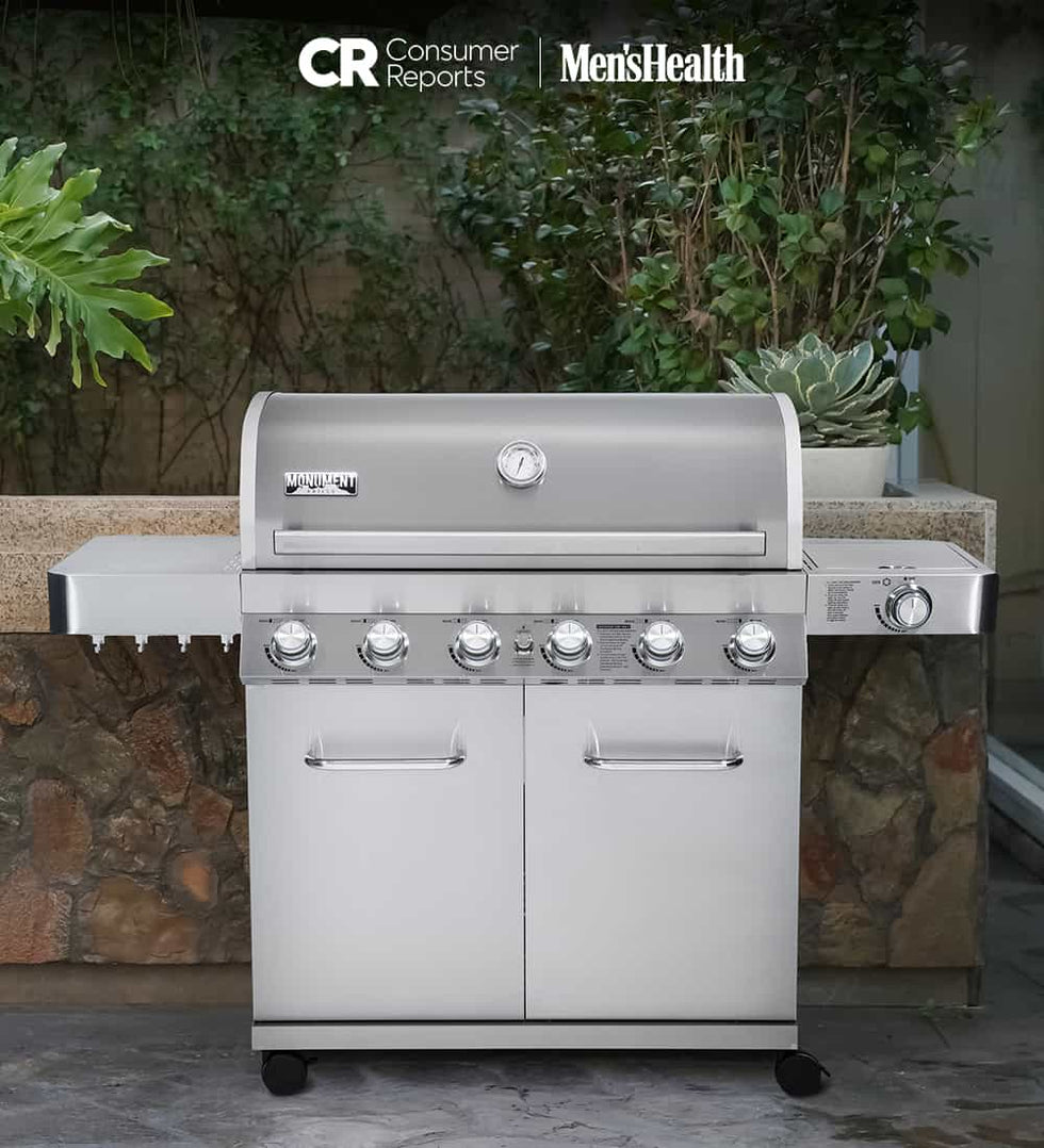 Stainless steel barbecue grill with 'CR Consumer Reports' and 'Men's Health' logos in an outdoor setting.