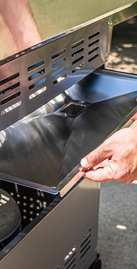 Person using a tool on a grill