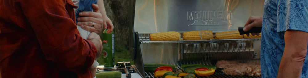 Friends gathering around a Monument grill outdoors