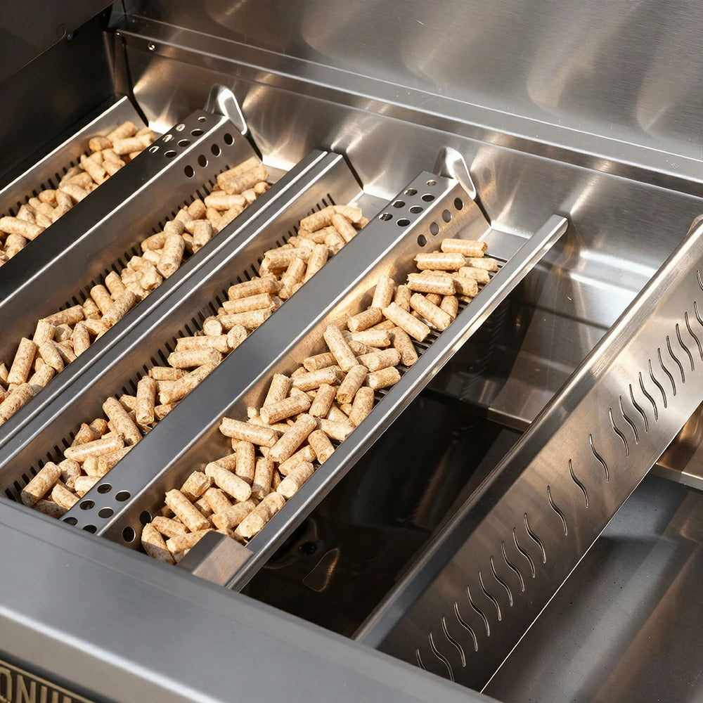 Metallic grill with wood pellets inside, likely for smoking food.