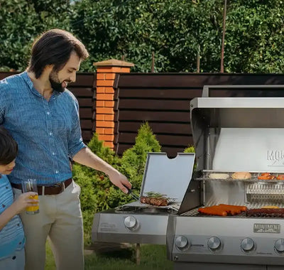 Man and child grilling outdoors with a Masterbuilt grill