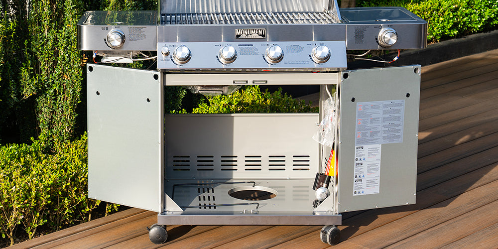 Barbecue grill with open lid on a wooden deck