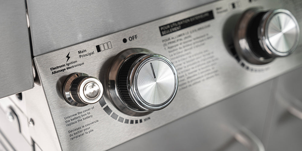 Control panel with knobs on a stainless steel appliance