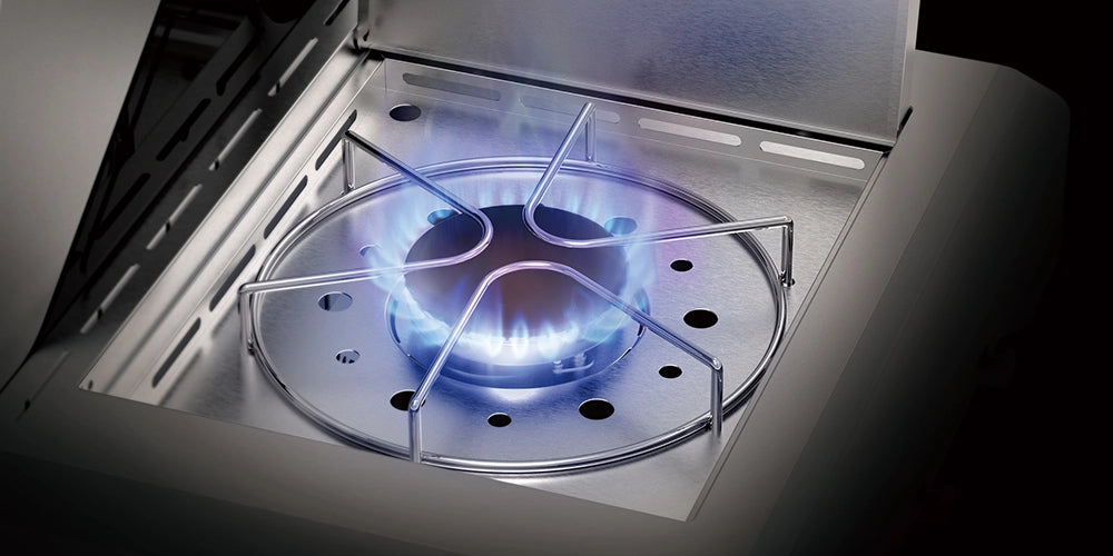 Gas stove burner with blue flame inside a kitchen setting