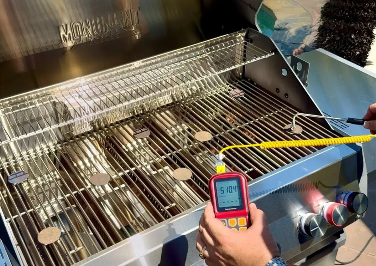 Grill with a digital thermometer showing temperature, brand 'Monarch' visible