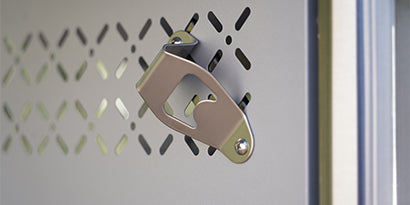 Metallic bottle opener on a textured metallic surface