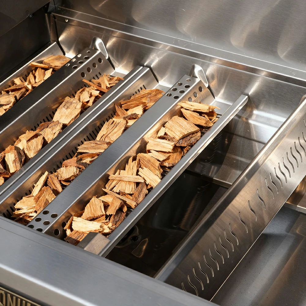 Wood chips in a smoker box on a grill