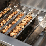 Wood chips in a smoker box on a grill