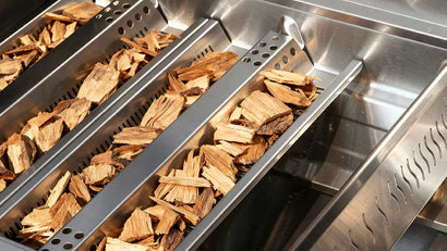 Wood chips in a smoker box on a grill