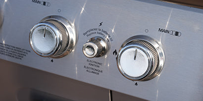 Control panel with two knobs on a metallic surface