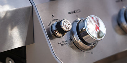 Close-up of gas stove knobs with metallic finish