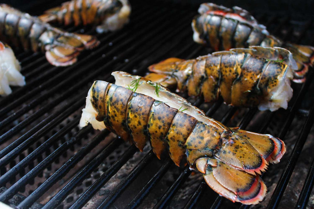 Lobster tails being grilled on a barbecue