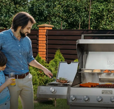 Man and child grilling outdoors with a Masterbuilt grill