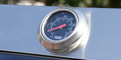 Temperature gauge on a metallic surface with blurred background