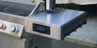 Stainless steel grill with digital display on a kitchen counter