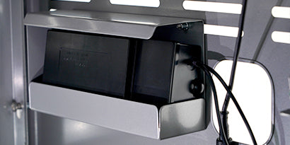 Close-up of a power strip with multiple outlets on a metallic surface.